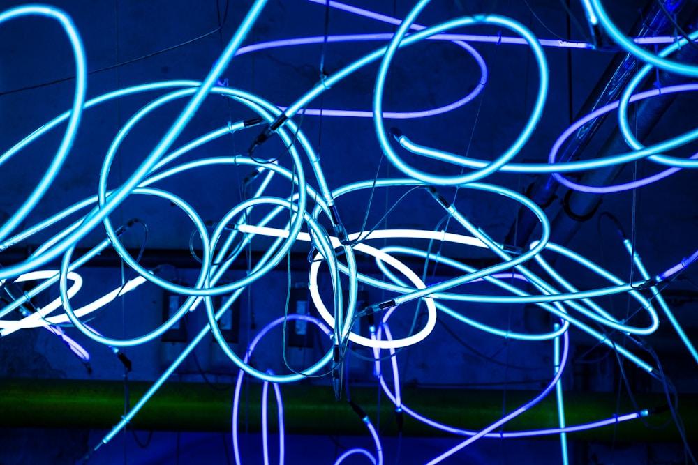 An abstract tangle of glowing blue neon tubes