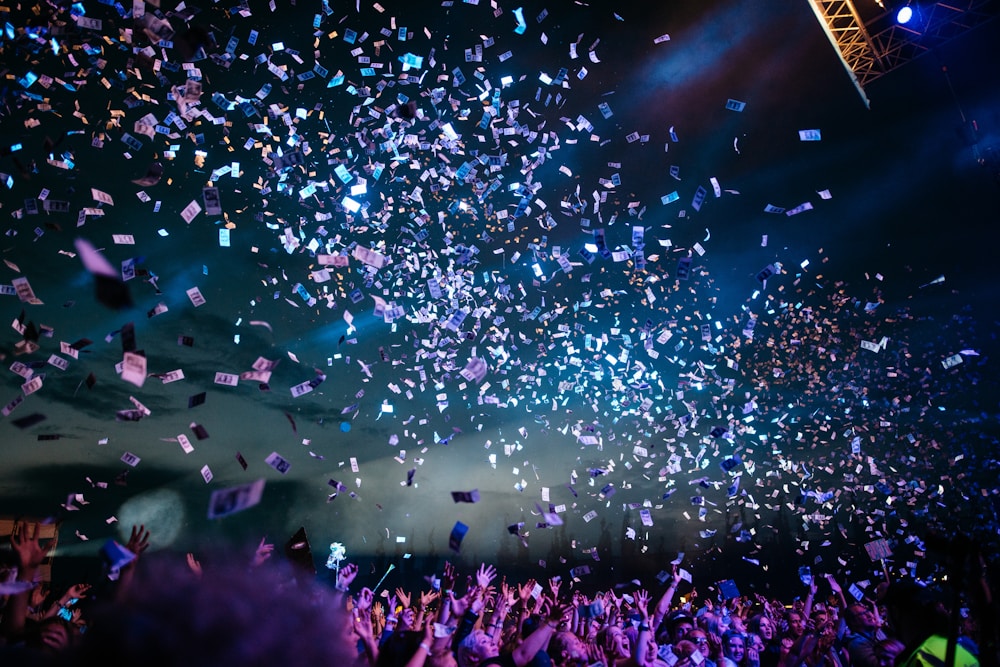 Confetti raining over a cheering concert crowd